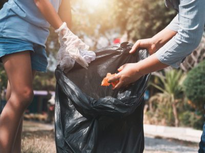 Mother and child help picking up trash at park