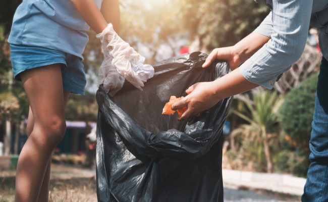 Mother and child help picking up trash at park