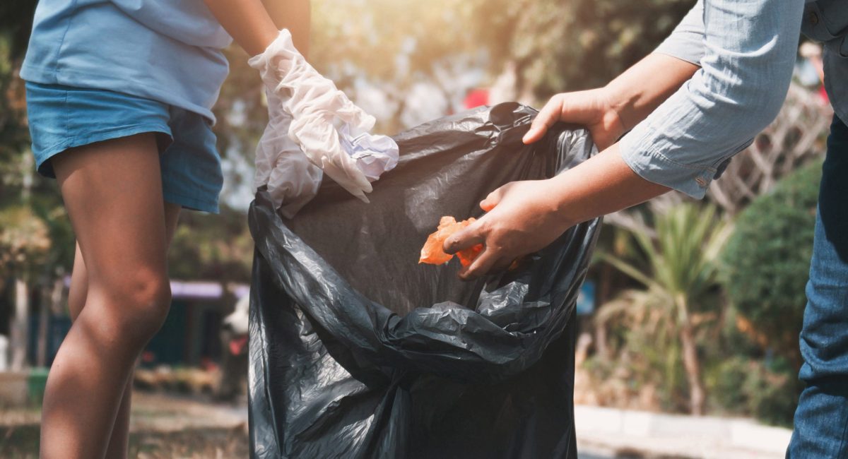 Mother and child help picking up trash at park